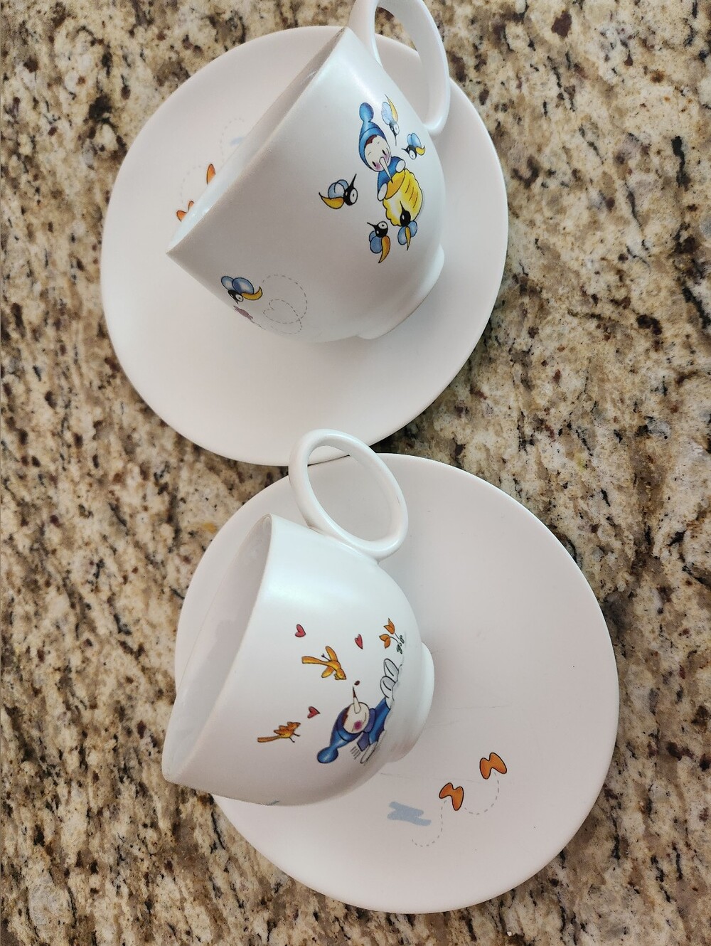 A di Alessi Cute White Ceramic 2 Tea Cups and 2 Saucers with Cute Characters